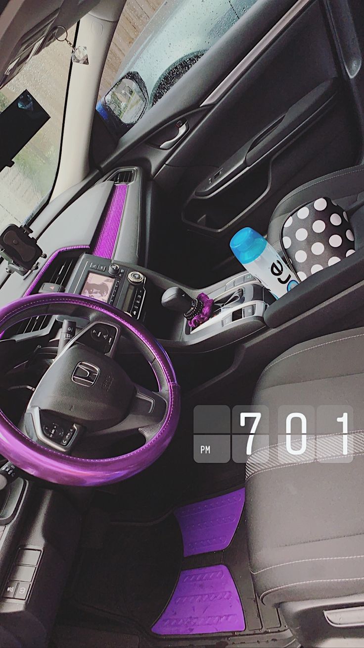 the interior of a car with purple trim and steering wheel, dash board, and other accessories