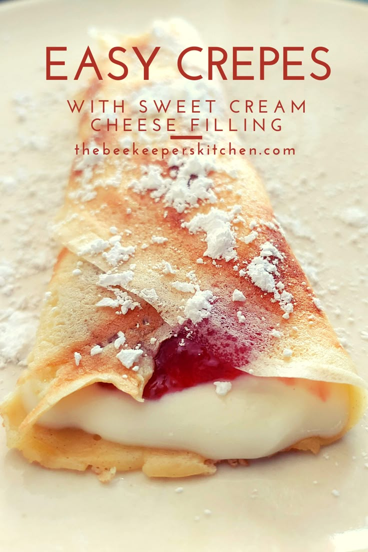 an easy crepe with sweet cream and cheese filling on a white plate topped with powdered sugar