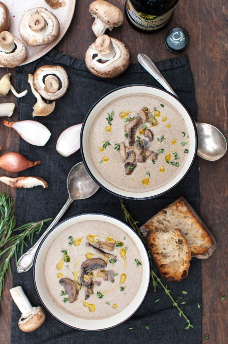 two bowls of mushroom soup on a table