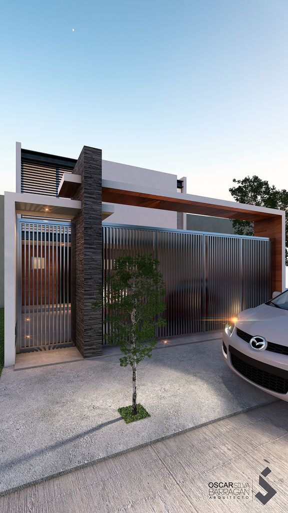 a car is parked in front of a modern house with an entry way and garage