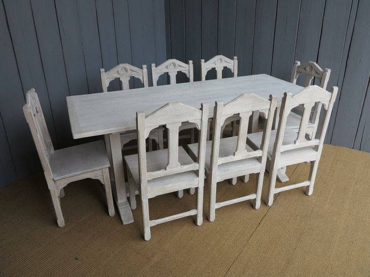 a table and chairs made out of wood with no one sitting at the table in front of them