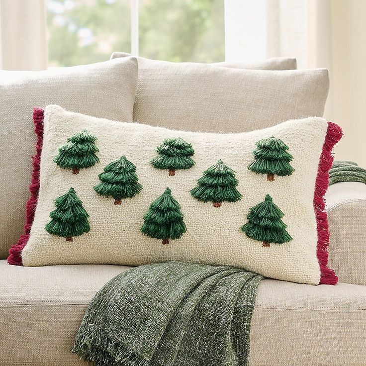 a white couch with green christmas trees on it