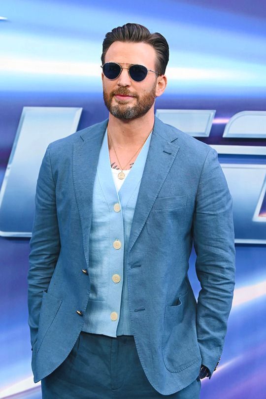 a man wearing sunglasses and a blue suit