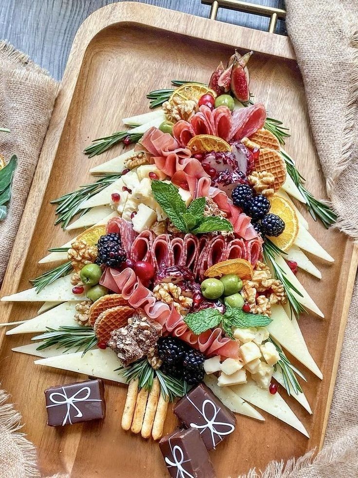 a wooden platter filled with fruit and veggies