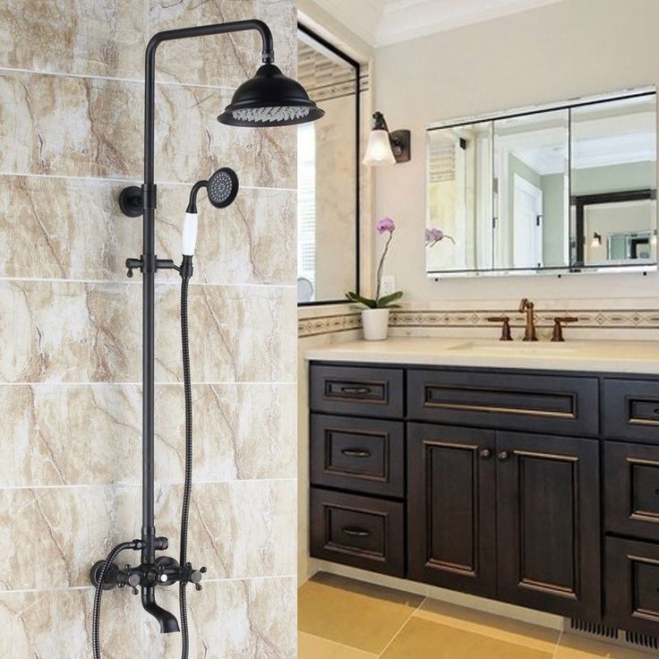 a bathroom with a sink, mirror and shower head in it's center area