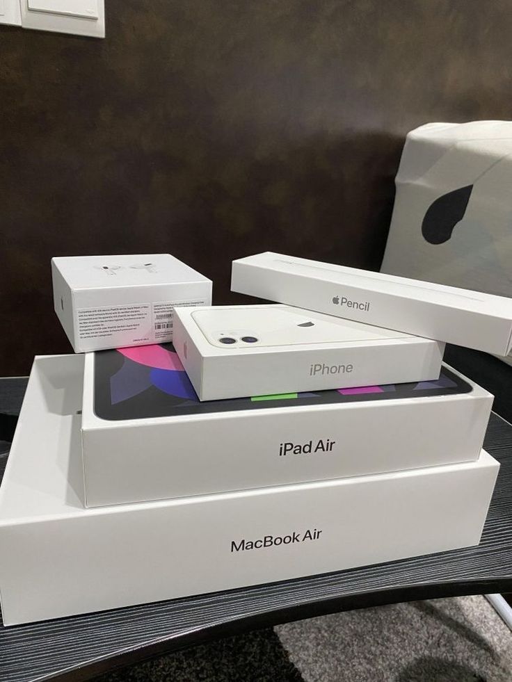 two boxes are stacked on top of each other in front of an apple product box