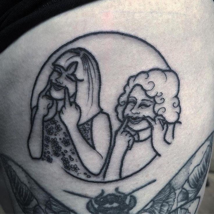 a woman's thigh with an image of two women on it