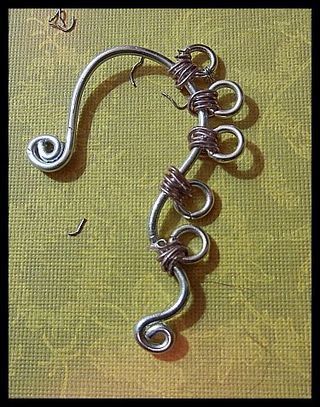 a piece of metal that has been made to look like a hook with two loops on it