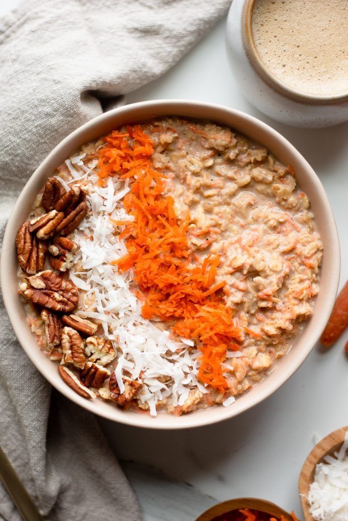 a bowl of oatmeal with carrots and pecans