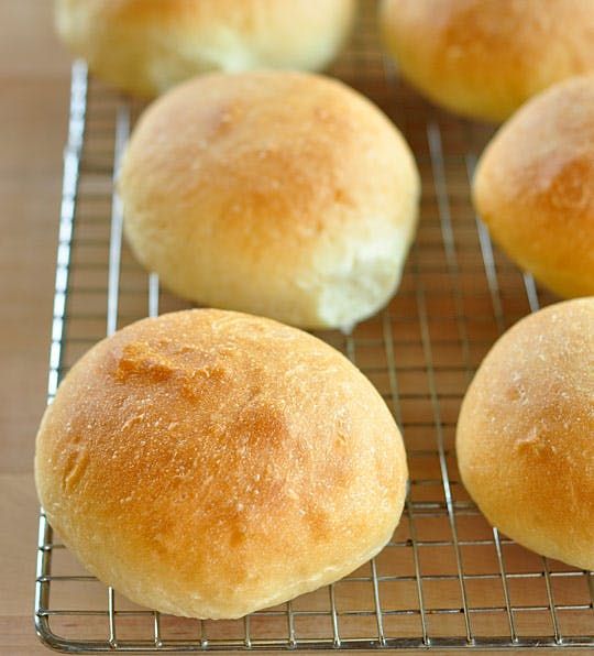 several rolls cooling on a wire rack in the kitchen, ready to be baked into buns