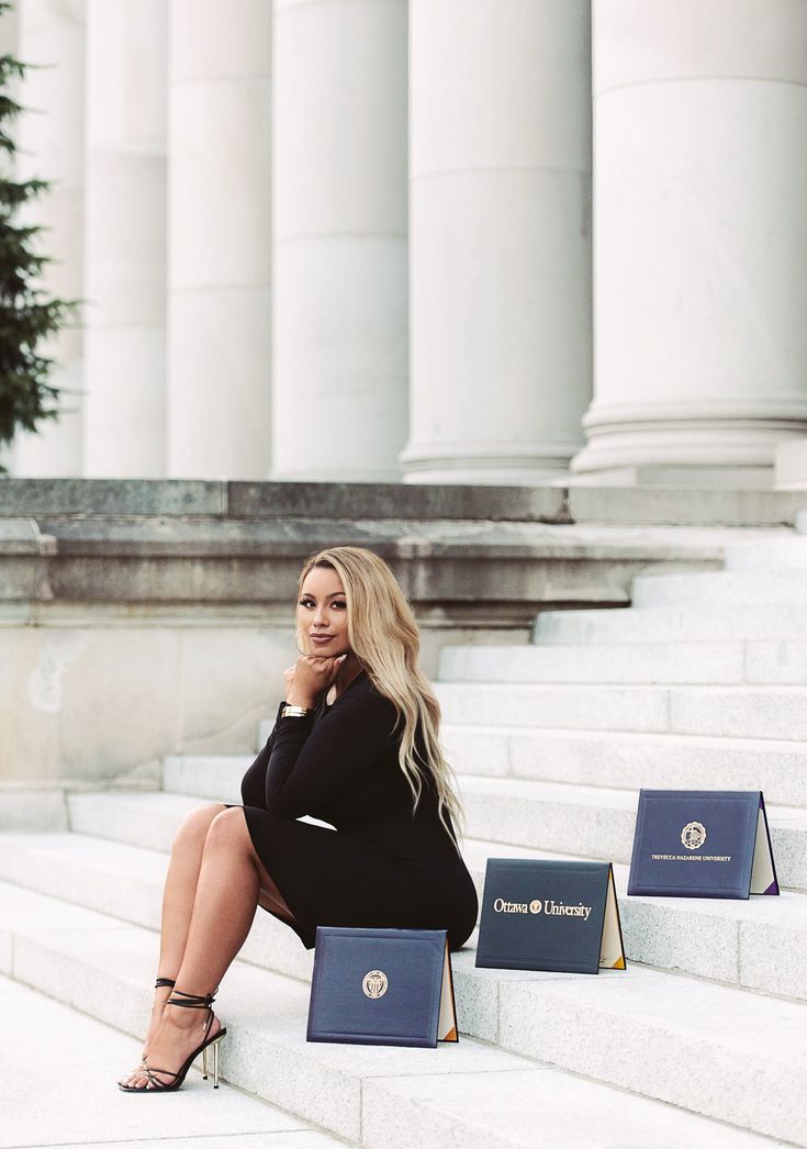 a woman is sitting on the steps with her laptop and folders in front of them