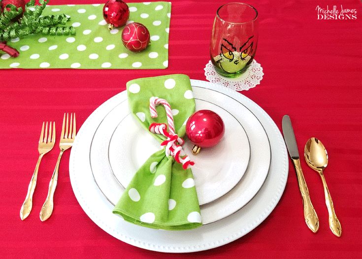 the place setting is ready to be served for christmas dinner guests will enjoy it with red and green napkins