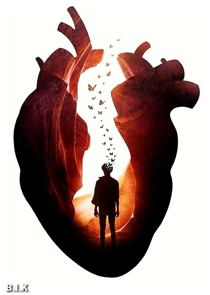 a man standing in front of a giant heart with birds flying out of it's side