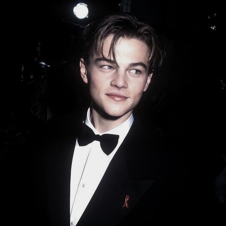 a young man in a tuxedo and bow tie