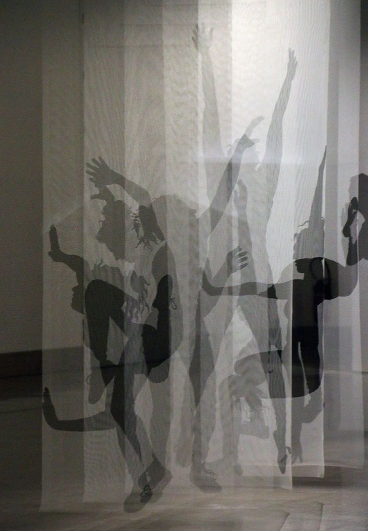 the silhouettes of two people are shown through sheer curtains