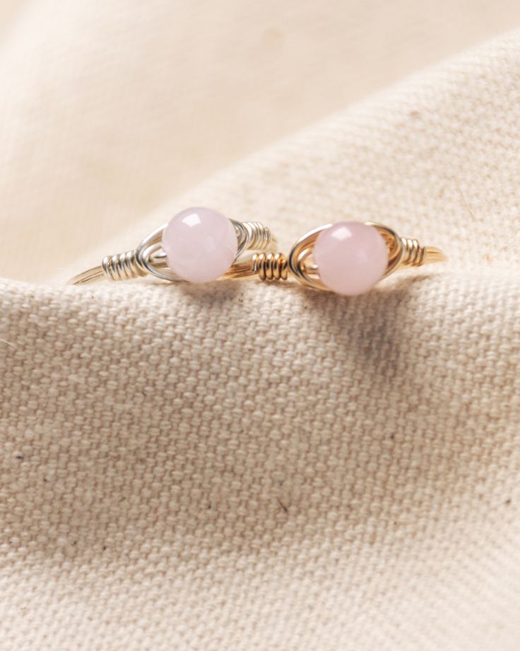 Our minimalist, most layered, wire-wrapped rings are going to be your newest obsession! Mix and match to create your own style with our endless ring layered combinations! Rose Quartz gem stone stands as the stone of love and compassion. The finest emotional healer, Rose Quartz, opens the heart to attract beauty and love of all kinds. Kindness Gems rings are hand-wrapped with 14k gold-fill & silver, which means more than durable and made to last! Rose Quartz Crystal Ring For Promise, Minimalist Rose Quartz Birthstone Jewelry, Promise Ring With Rose Quartz And Gemstone Detail, Adjustable Rose Quartz Rose Gold Ring, Minimalist Rose Quartz Gemstone Jewelry, Pink Minimalist Midi Rings, Elegant Stackable Rose Quartz Jewelry, Dainty Rose Quartz Gemstone Jewelry, Rose Gold Rose Quartz Promise Ring