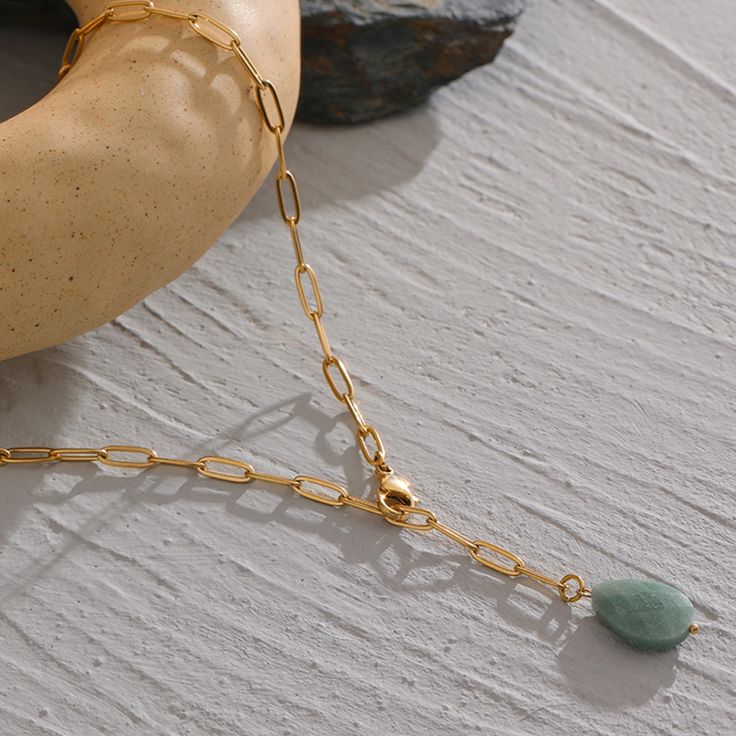 Introducing our newest and most unique accessory, the Green Agate Necklace by ASANA Crystals! This beautiful piece is perfect for those who love minimalism and want to add a touch of nature-inspired elegance to their look. The Green Agate stone is known for its metaphysical properties and is said to promote emotional stability. It's the perfect way to add a bit of zen to your life!

 	Size: 18 inches
 	Free Shipping 2 Days
 	Authentic Green Stone: Green Agate
 	Gold Plated Agate Stone Necklace, Buy Necklace, Perfect Marriage, Meaningful Jewelry, Green Agate, Agate Necklace, Agate Crystal, Crystal Shop, Agate Pendant