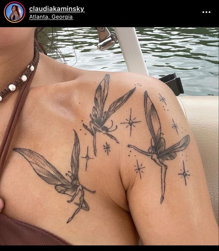 a woman with tattoos on her chest sitting in a boat