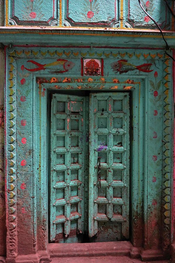 an old wooden door with intricate designs painted on it