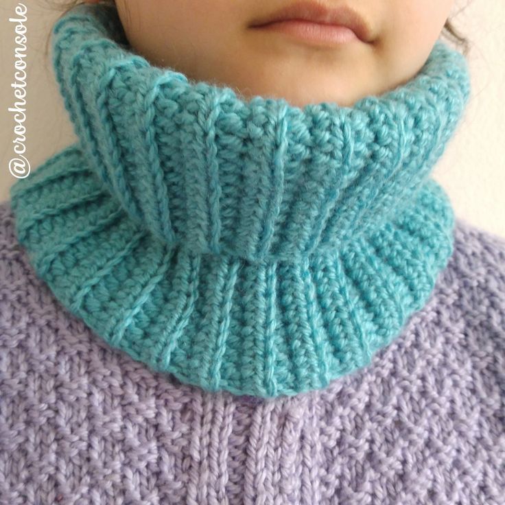 a close up of a person wearing a knitted cowl