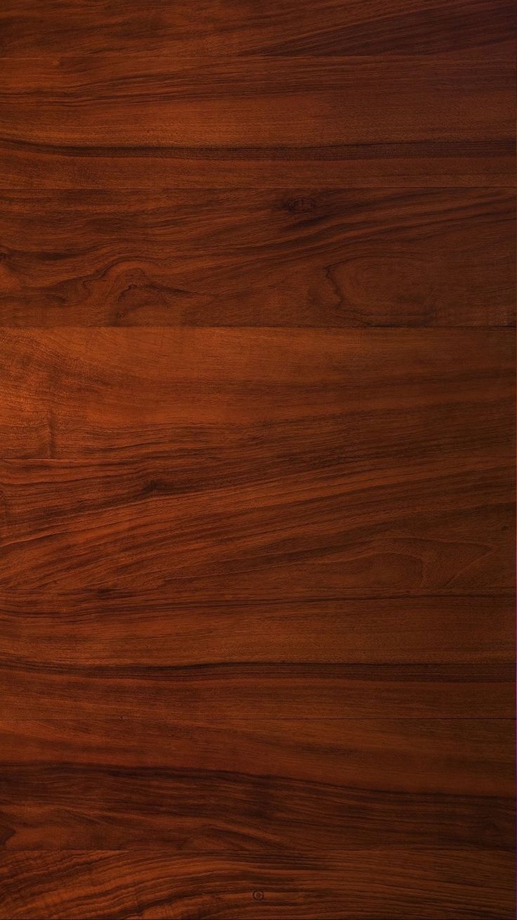 a close up view of a wooden surface with dark wood grains on the edges