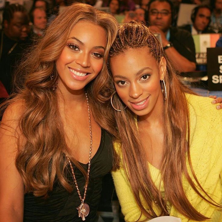 two beautiful young women sitting next to each other