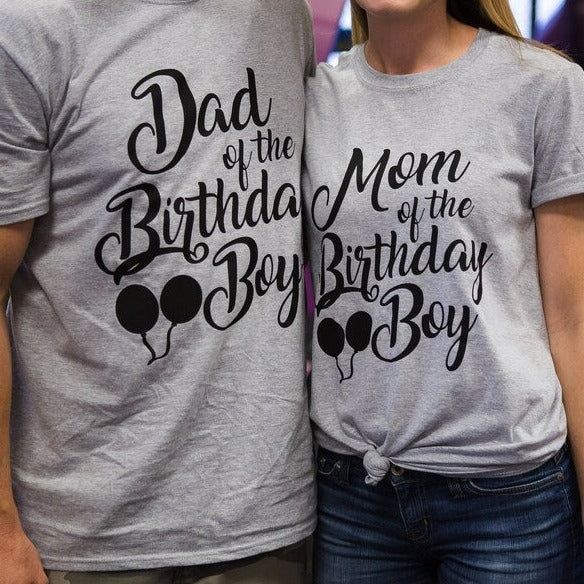 two people wearing shirts that say dad and the birth of the birthday boy on them