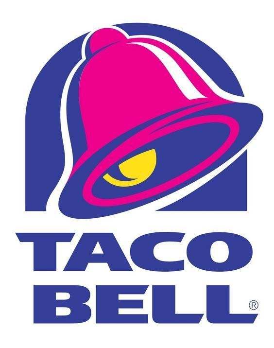 a woman standing next to a taco bell sign