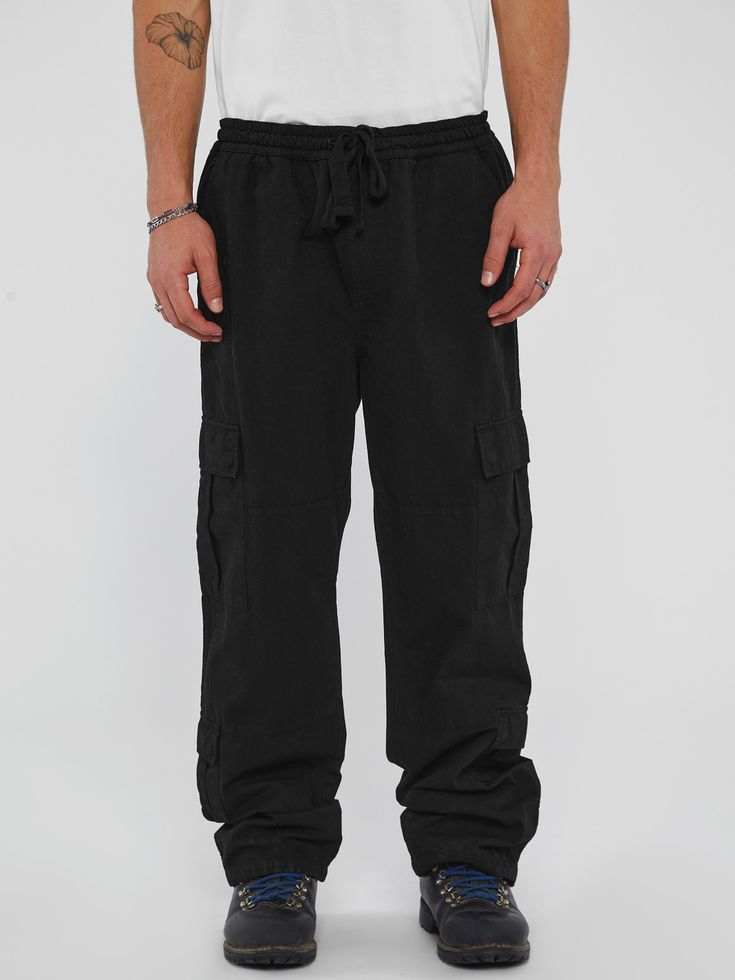 Woven ripstop cargo pants Super high-rise, sits at natural waist Relaxed fit and bootcut leg with drawstring ankle cuffs Elastic waistband with drawstring Eight-cargo pocket construction 19.5" Leg opening. 31.5" Inseam. Measurements taken from a size M. 100% Cotton Machine wash Relaxed Fit Cotton Combat Parachute Pants, Relaxed Fit Combat Bottoms With Cargo Pockets, Combat Cargo Pants With Relaxed Fit And Cargo Pockets, Combat Style Cargo Pants With Relaxed Fit, Combat Style Relaxed Fit Bottoms With Side Pockets, Combat Style Bottoms With Side Pockets And Relaxed Fit, Relaxed Fit Combat Bottoms With Side Pockets, Combat Bottoms With Side Pockets Relaxed Fit, Relaxed Fit Black Cargo Pants With Drawstring