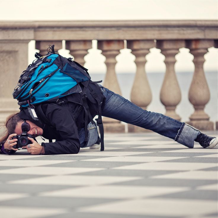 a man laying on the ground with a camera