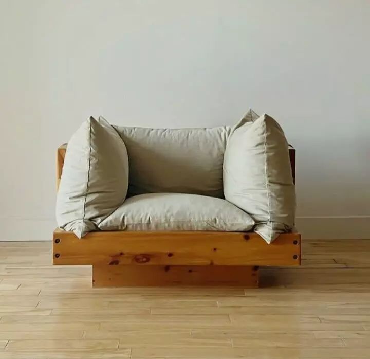 a wooden chair with two pillows on it