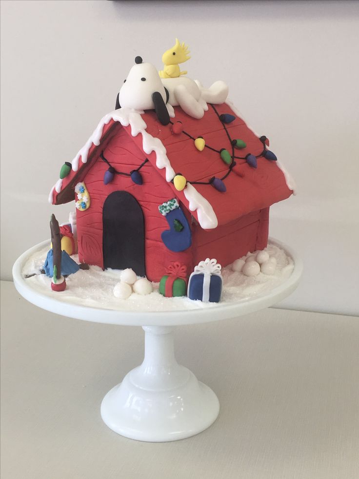 there is a cake that looks like a house with decorations on the roof and sides