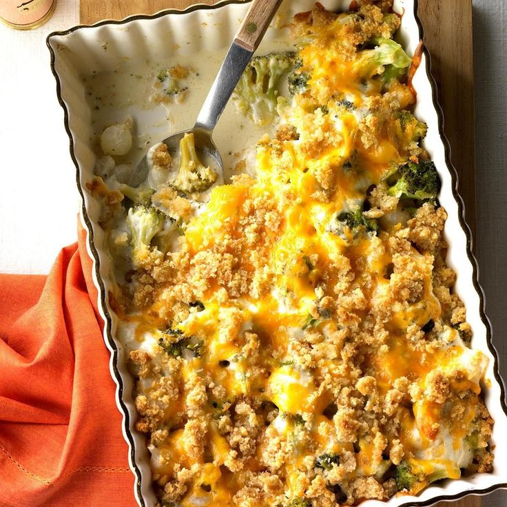 a casserole dish with broccoli, cheese and bread crumbs