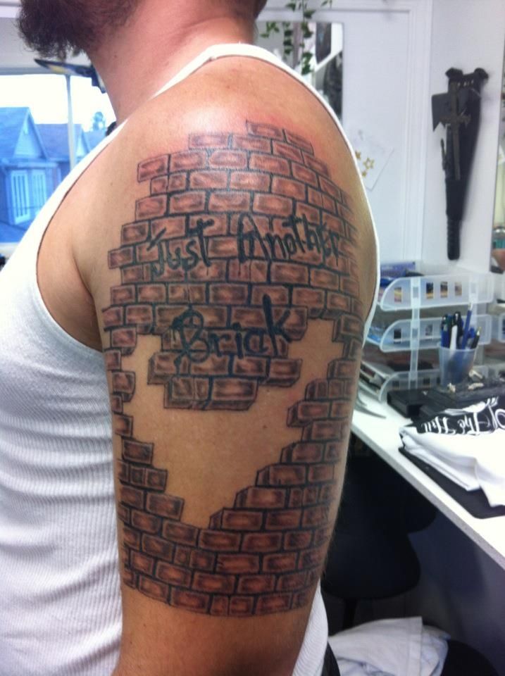 a man with a tattoo on his arm that has words written in the shape of a heart