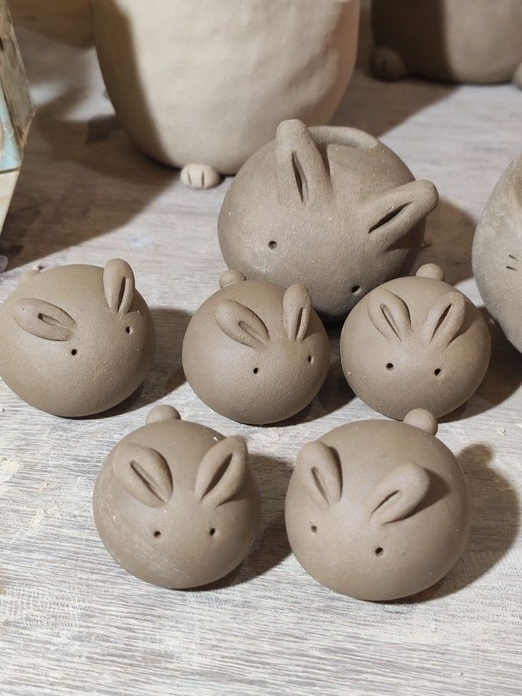 five clay figurines sitting next to each other on a table