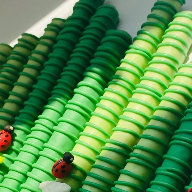 several green and yellow plastic beads with ladybugs on them sitting next to each other