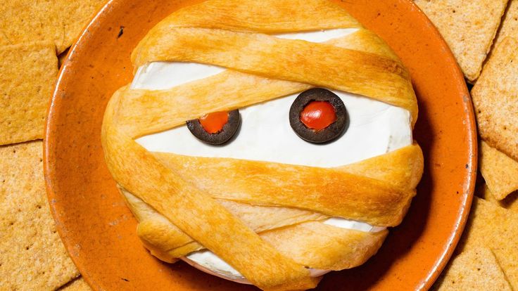 a plate with crackers wrapped around it and eyes