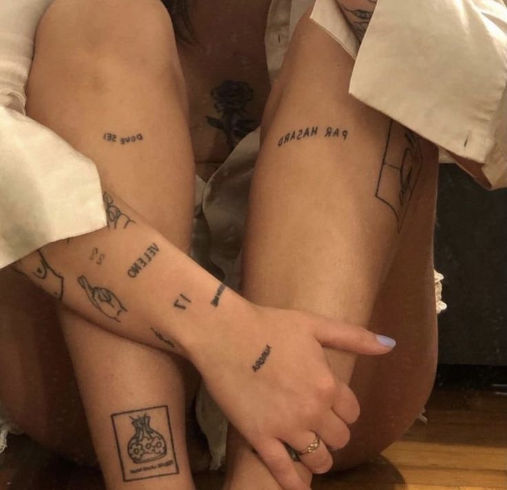 two people with matching tattoos on their legs