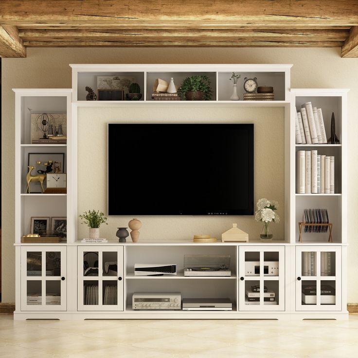 an entertainment center with bookshelves and a flat screen tv mounted on the wall