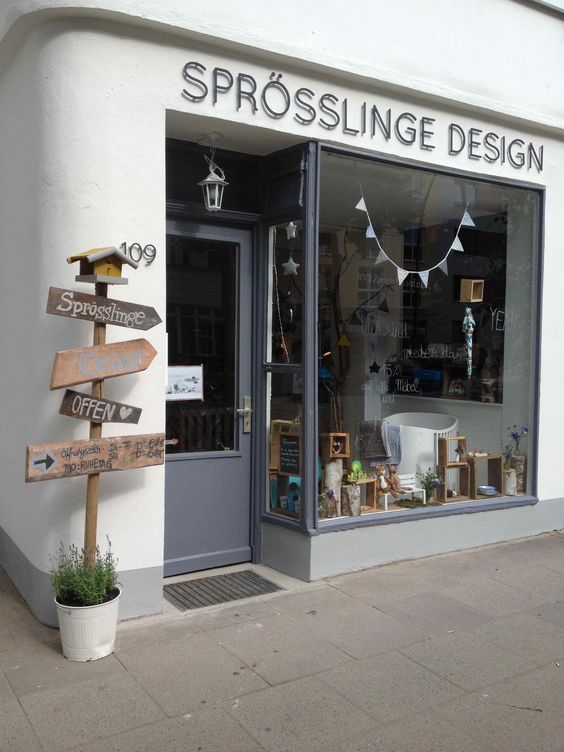 a store front with several wooden signs in the window