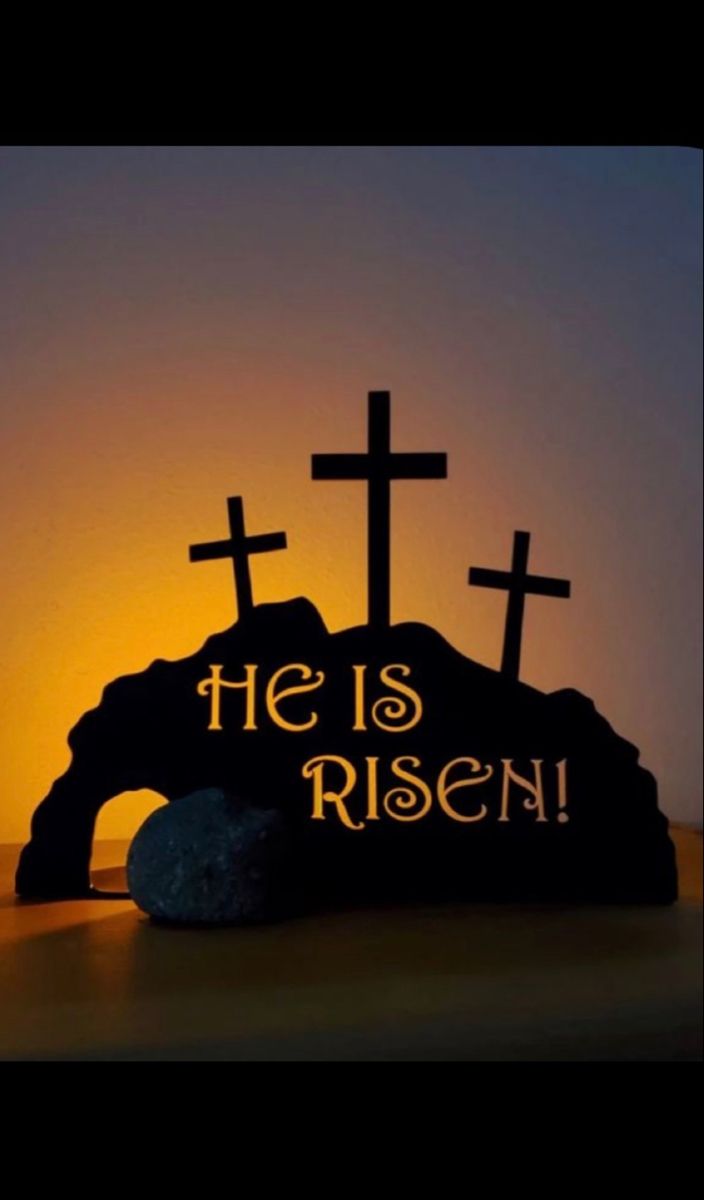 a rock with crosses on it and the words he is risen