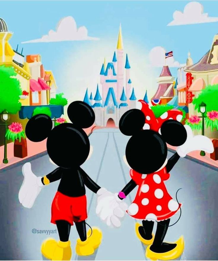 two mickey and minnie mouses are walking down the street in front of a castle