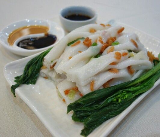 a white plate topped with food next to dipping sauce