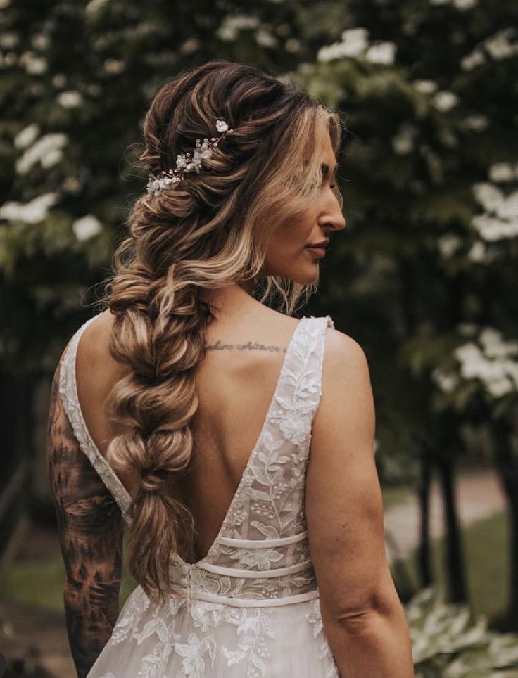 a woman with long hair wearing a wedding dress