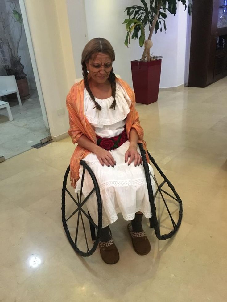 a woman sitting in a wheel chair on the floor