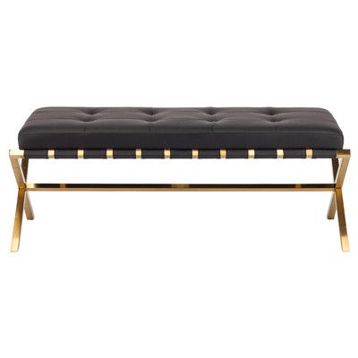 a black and white bench with gold legs