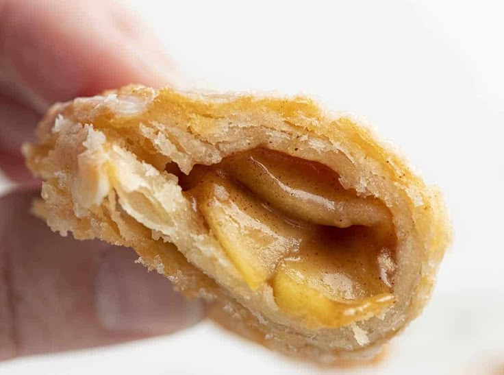 a half eaten pastry being held in someone's hand