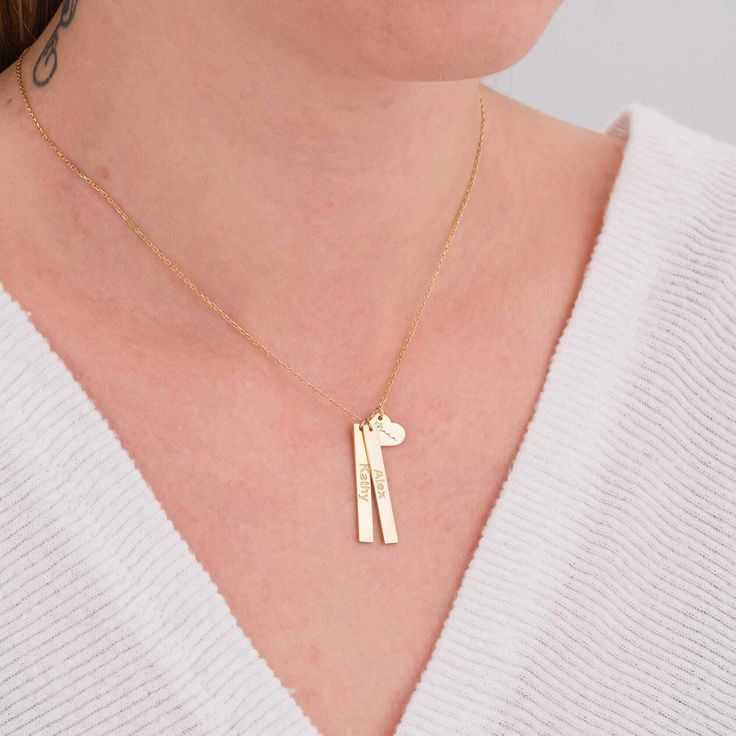 ✨ Welcome to our exquisite collection of personalized handmade jewelry, where every piece tells a unique story of love and connection. Elevate your style with our stunning 14K Gold Vertical Two Bar With Heart Necklace, a timeless treasure crafted with meticulous attention to detail. 💖 This enchanting necklace features two vertical bars delicately intertwined with a heart, symbolizing the bond between loved ones. Each bar is elegantly engraved with the names of your choice, making it a cherished Minimalist Customizable Charm Necklace For Anniversary, Elegant Hand Stamped Necklace For Anniversary Gift, Minimalist Personalized Jewelry For Anniversary, Customizable Minimalist Heart Pendant Jewelry, Minimalist Customized Jewelry For Mom, Customizable Heart Pendant Jewelry For Mom, Hand Stamped Nameplate Jewelry For Anniversary, Customizable Heart Pendant Jewelry Gift For Mom, Hand Stamped Nameplate Jewelry For Anniversary Gift