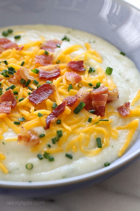 a white bowl filled with cheese and bacon