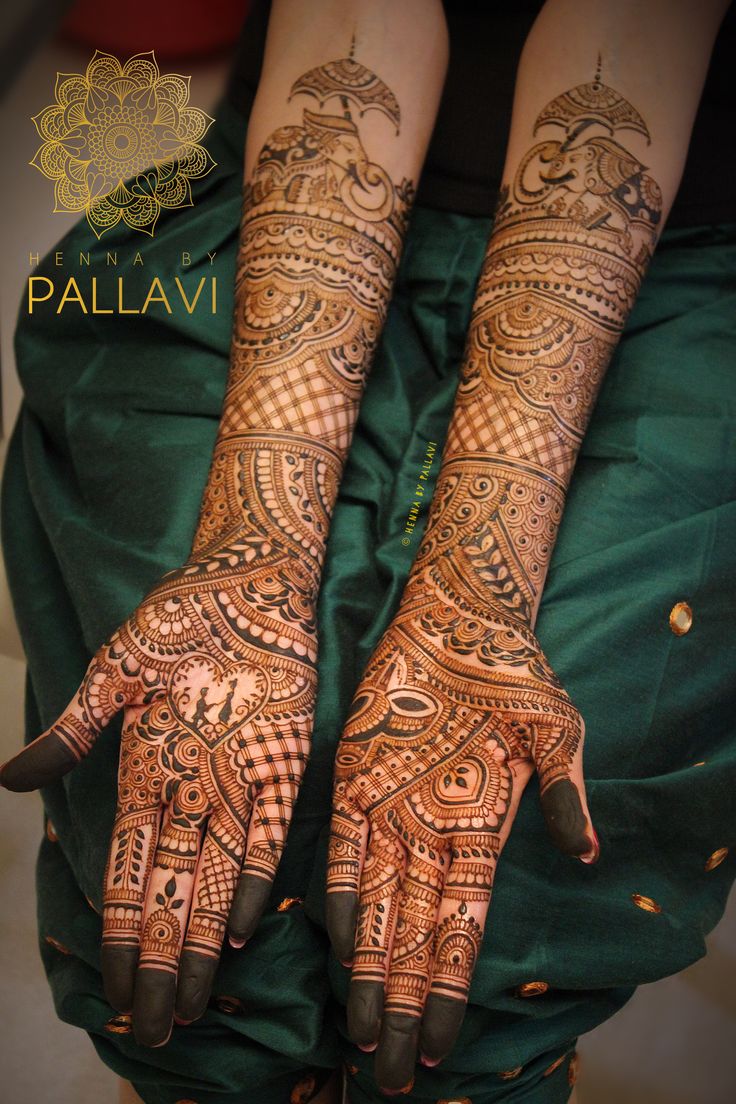 two hands with henna tattoos on them, one is showing the intricate pattern and the other has an elaborate design